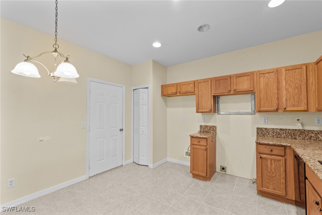 4031 Cherrybrook Loop Fort Myers, FL 33966 - Photo 2 of 34 a kitchen with granite countertop white cabinets and stainless steel appliances