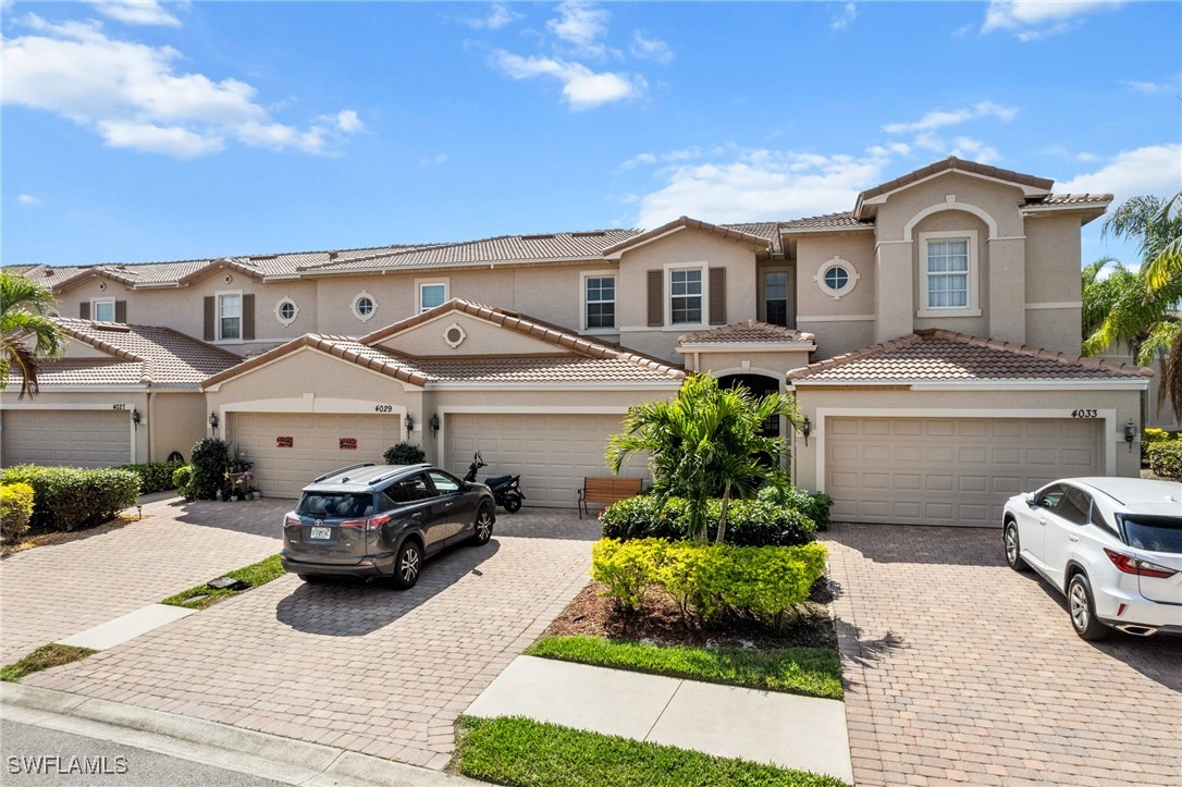 4031 Cherrybrook Loop Fort Myers, FL 33966 - Photo 23 of 34 a front view of a house with a garden and parking space