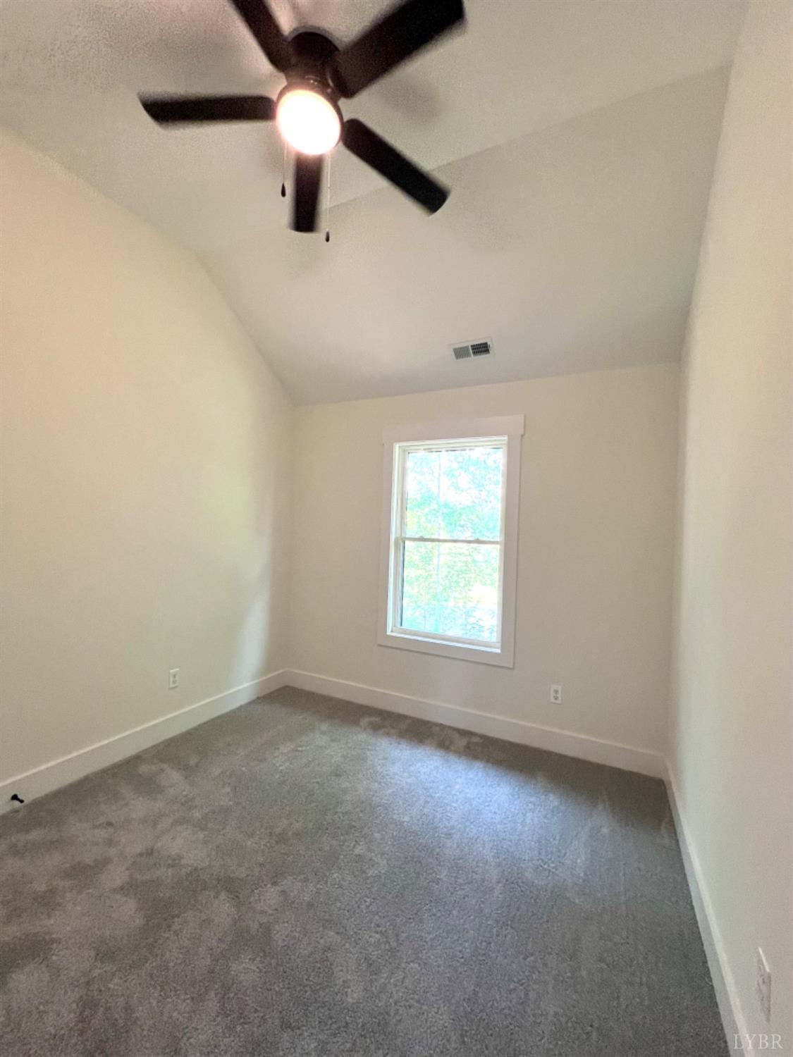 2638 Sunnymeade Road, Unit A&B Rustburg, VA 24588 - Photo 19 of 25 an empty room with a ceiling fan and a window