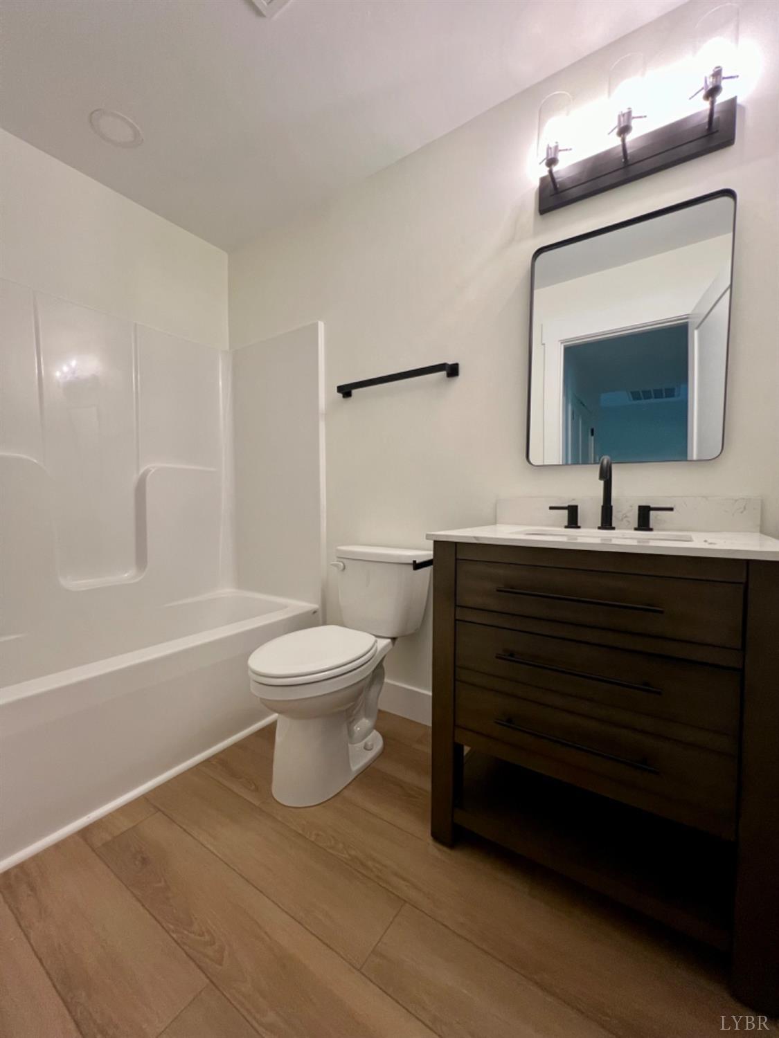 2638 Sunnymeade Road, Unit A&B Rustburg, VA 24588 - Photo 20 of 25 a bathroom with a toilet a sink a mirror and bathtub
