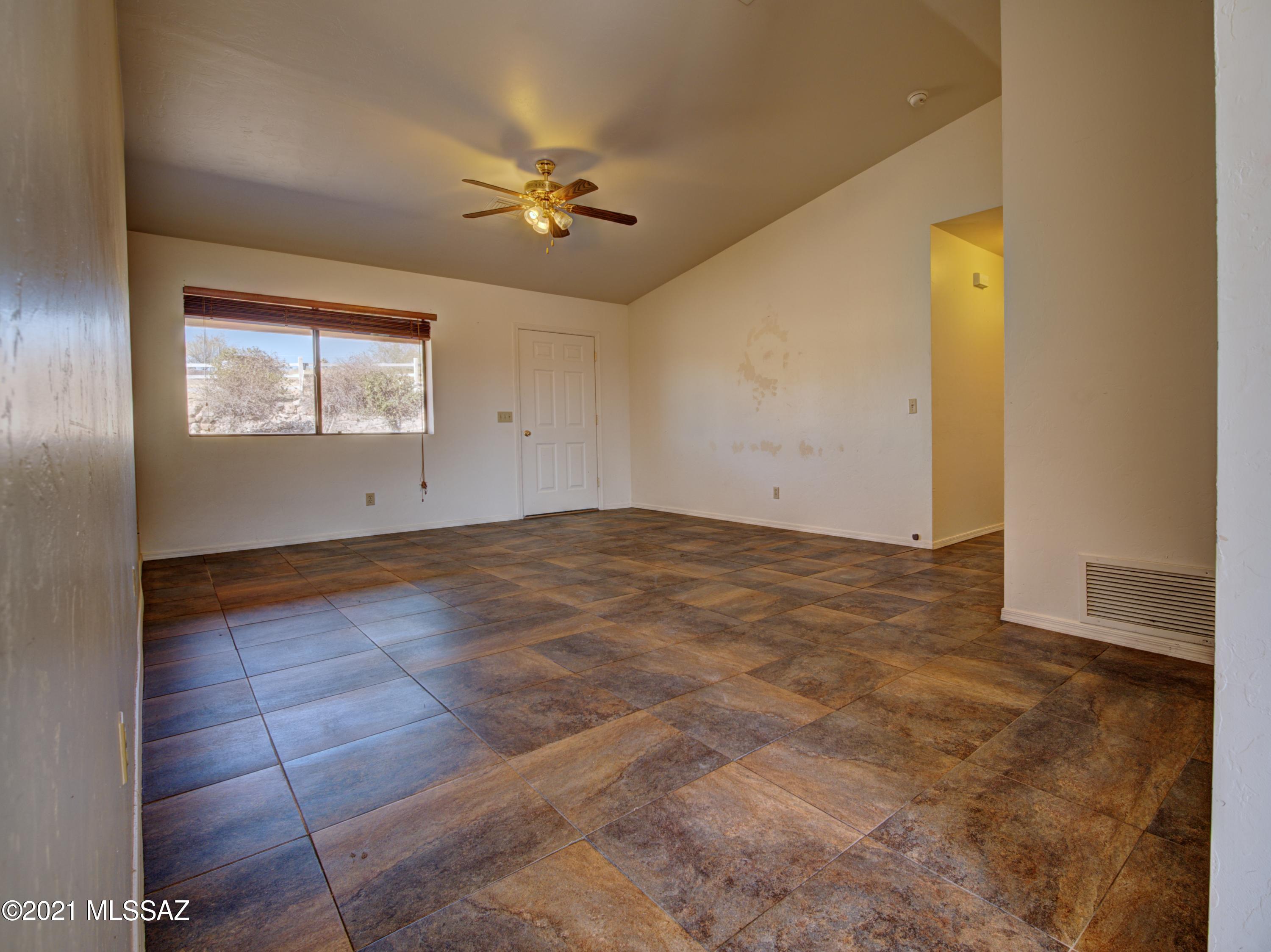 381 Tala Court Rio Rico, AZ 85648 - Photo 7 of 19 an empty room with windows and chandelier fan
