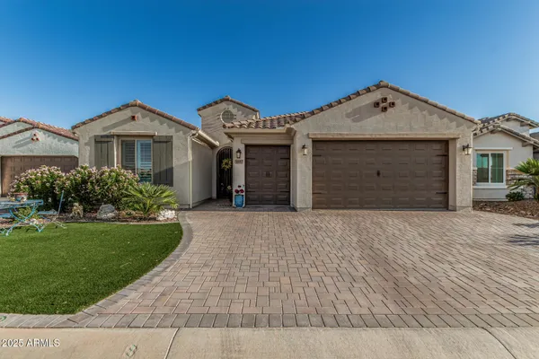 a front view of a house with a yard and garage