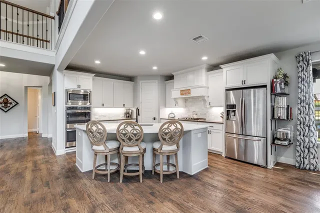 a view of living room with stainless steel appliances granite countertop furniture and a large window