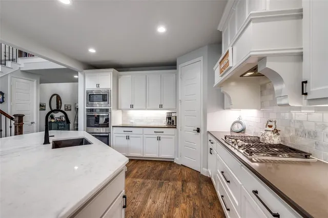 a bathroom with a granite countertop toilet sink and mirror
