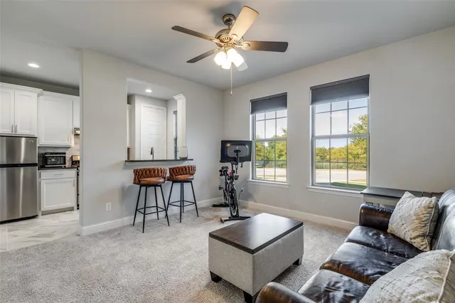 a kitchen with granite countertop a sink stainless steel appliances and window