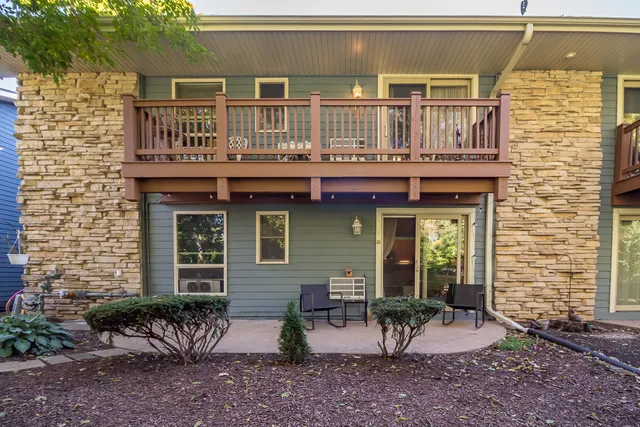a view of a house with a yard and sitting area