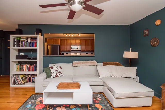 a living room with furniture and a book shelf