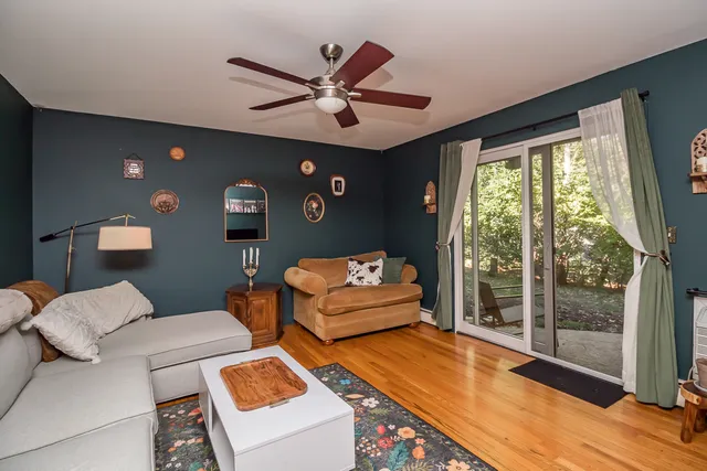a bedroom with furniture and a large window