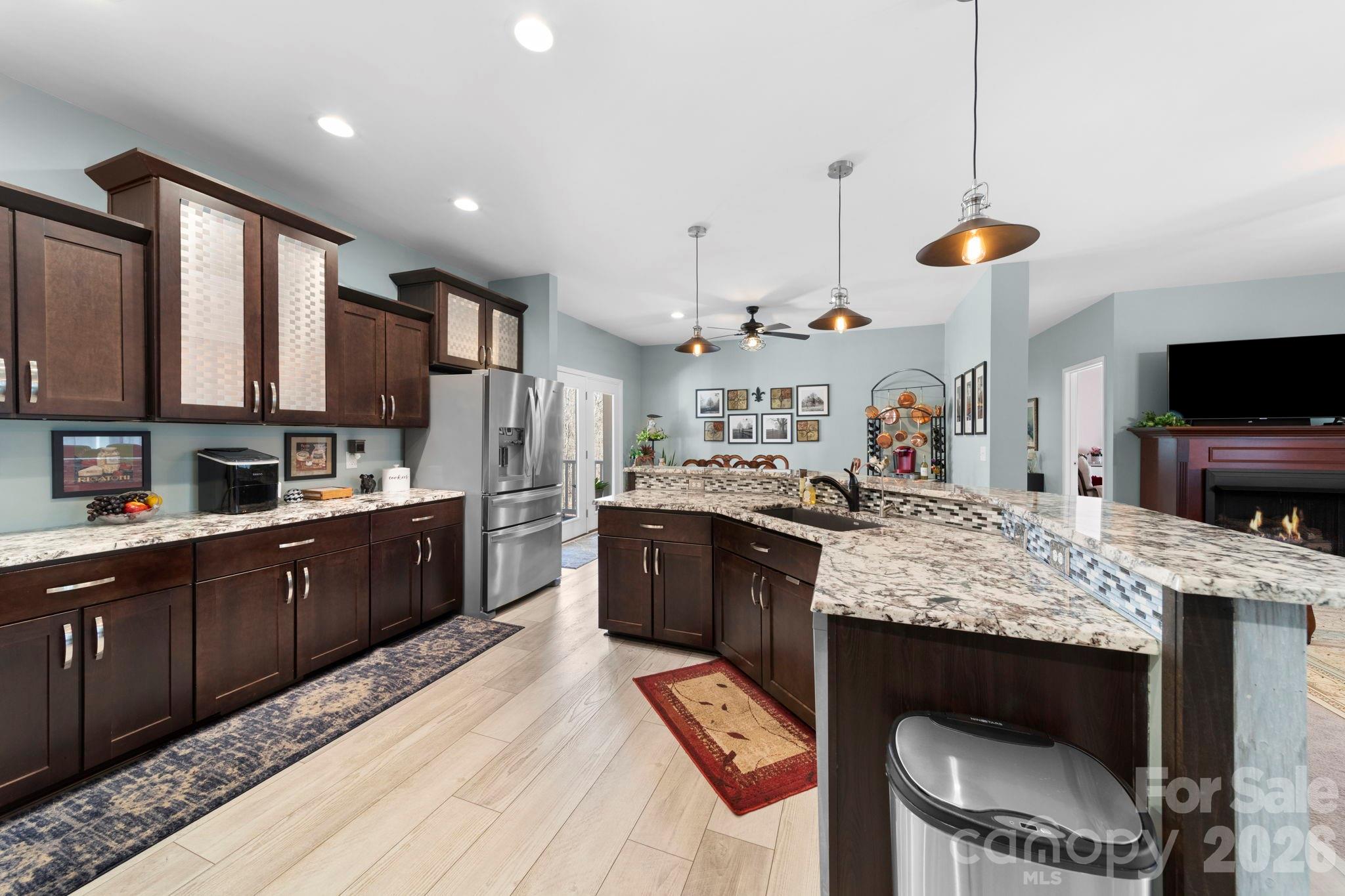 142 Will Evans Road Jefferson, SC 29718 - Photo 13 of 44 a large kitchen with kitchen island granite countertop wooden cabinets and a wooden floor