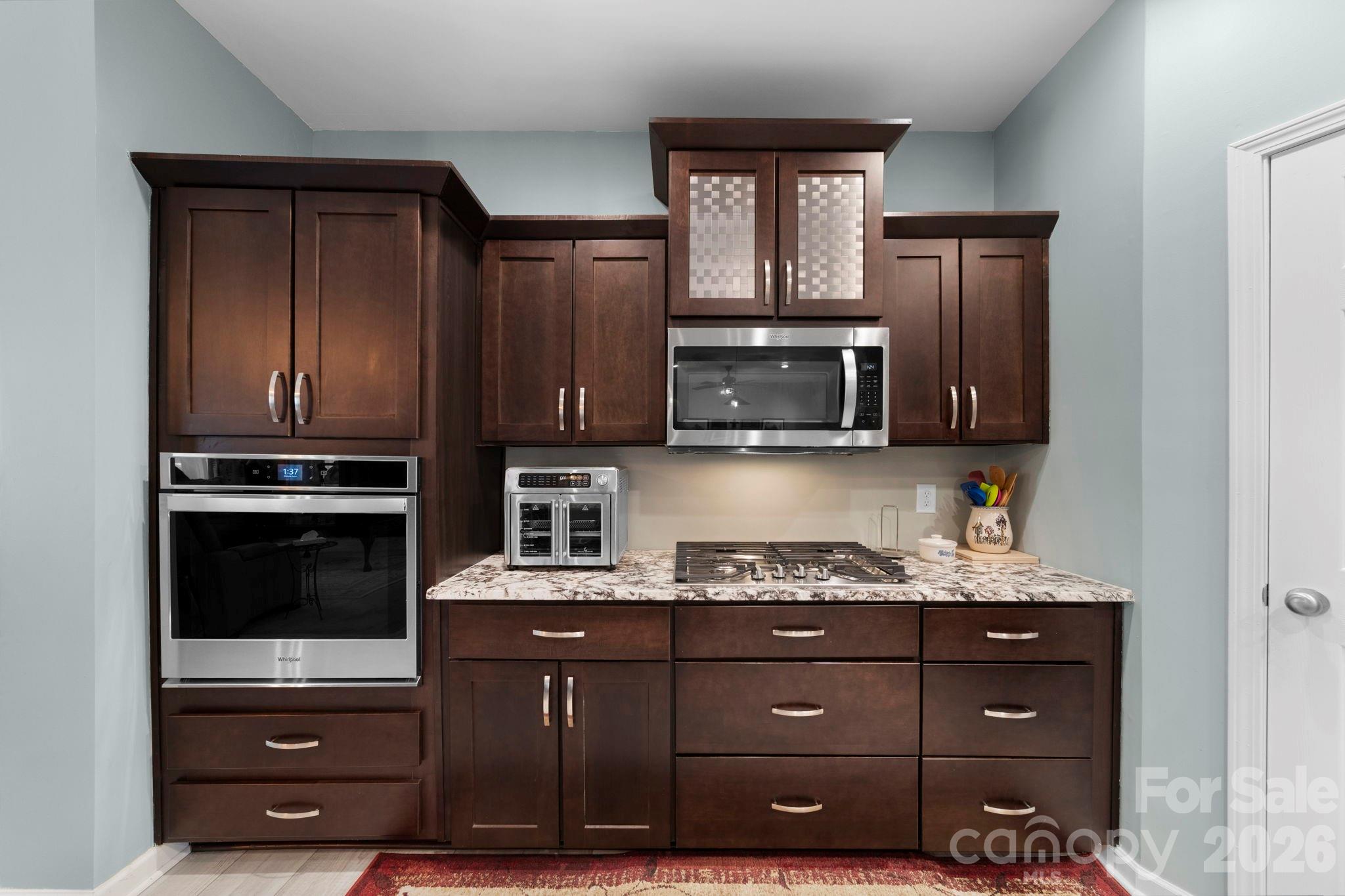 142 Will Evans Road Jefferson, SC 29718 - Photo 15 of 44 a kitchen with granite countertop wooden cabinets and stainless steel appliances