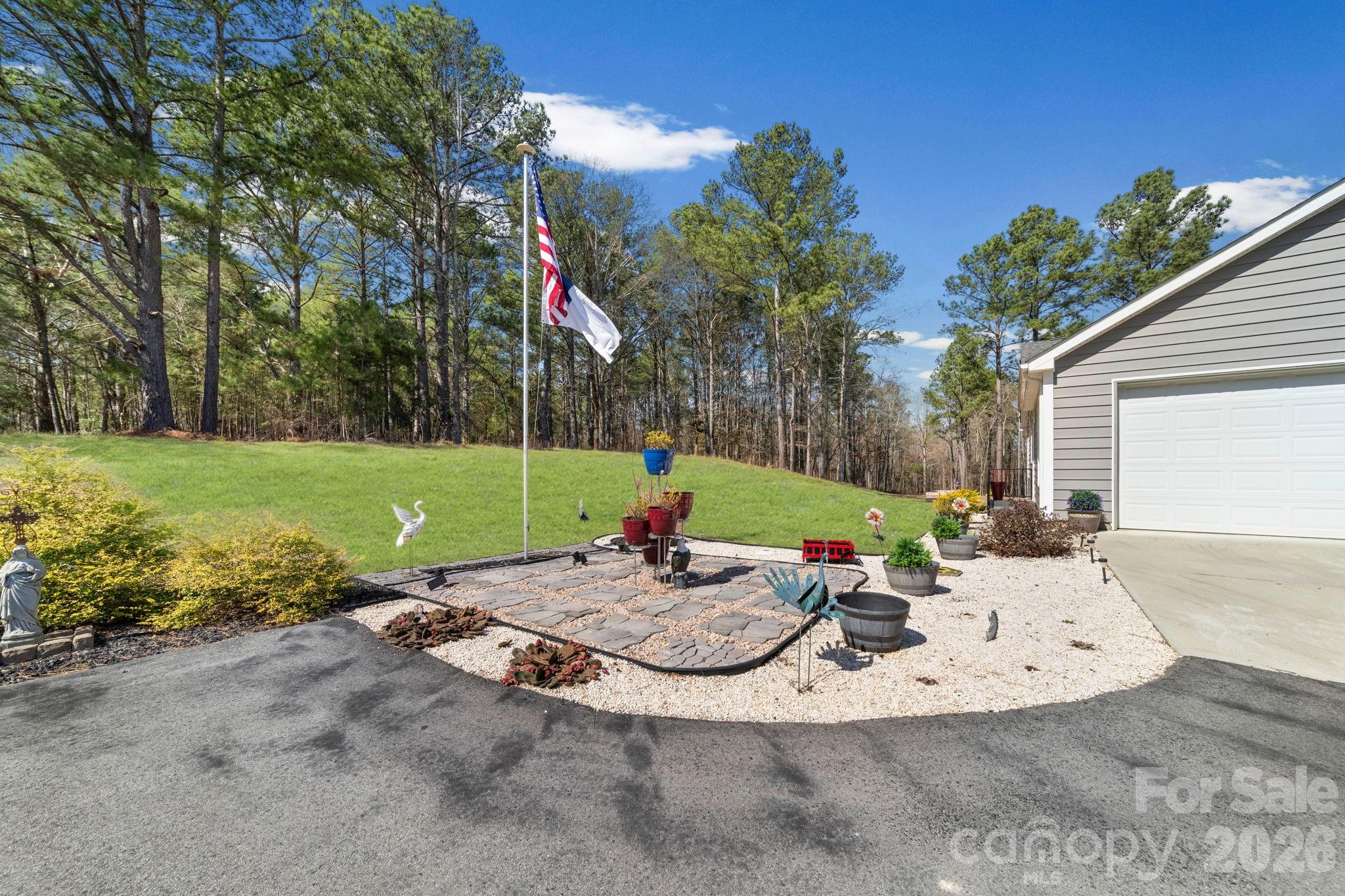 142 Will Evans Road Jefferson, SC 29718 - Photo 16 of 44 a view of a backyard with a garden and entertaining space