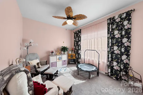 a living room with furniture flowers and a chandelier