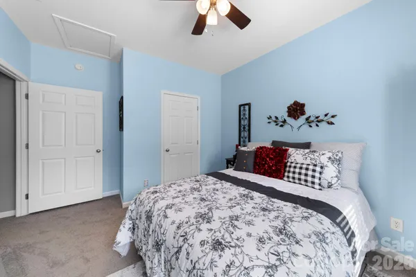 a bedroom with a bed and a chandelier