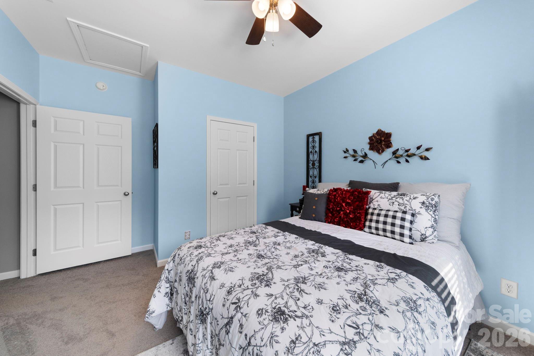142 Will Evans Road Jefferson, SC 29718 - Photo 19 of 44 a bedroom with a bed and a chandelier