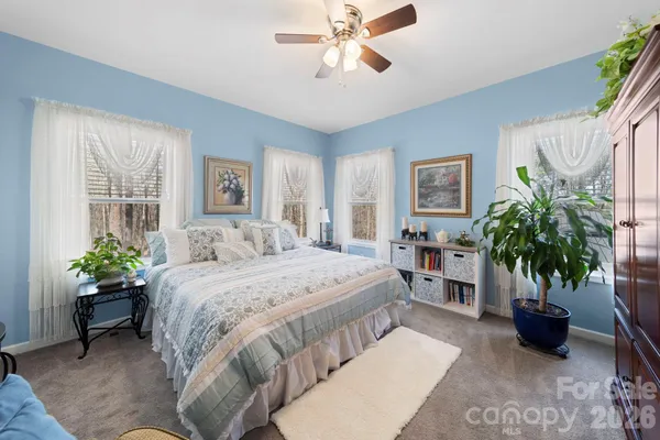 a bedroom with a bed and a potted plant