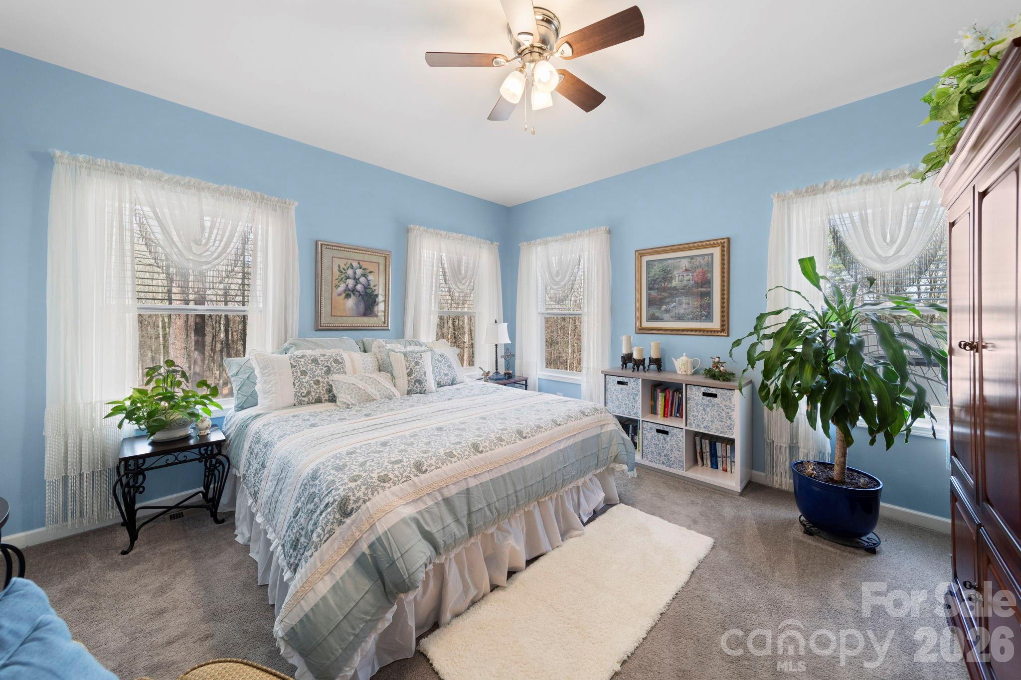 142 Will Evans Road Jefferson, SC 29718 - Photo 20 of 44 a bedroom with a bed and a potted plant