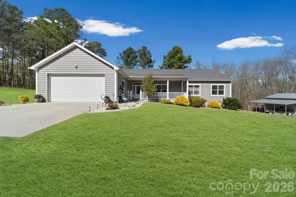 a view of a house with a backyard and a patio