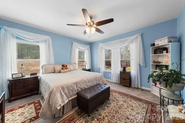 a bedroom with a large bed and a window