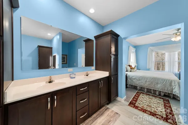 a spacious bathroom with a double vanity sink and a mirror