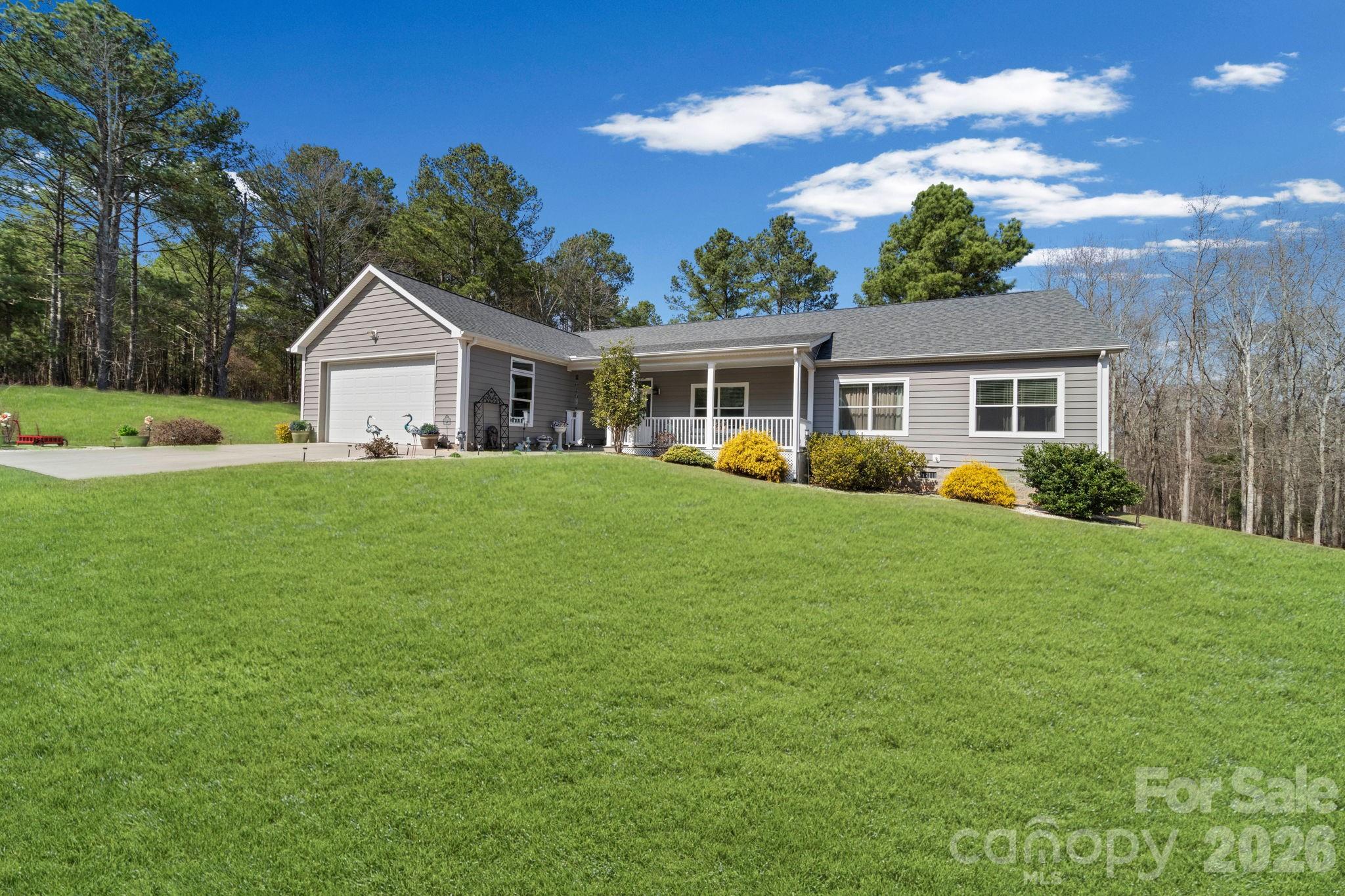142 Will Evans Road Jefferson, SC 29718 - Photo 3 of 44 a view of a house with a big yard and potted plants