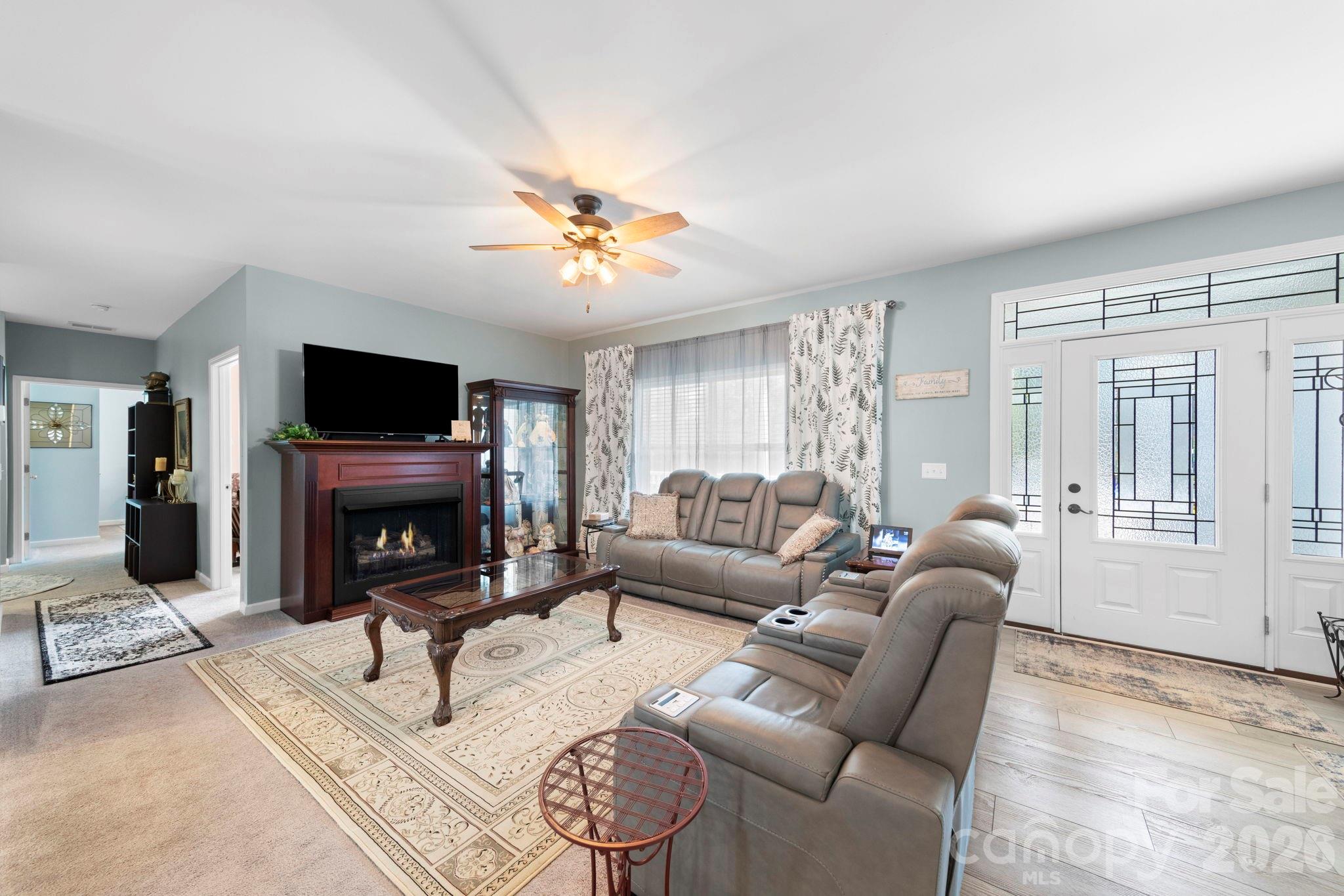 142 Will Evans Road Jefferson, SC 29718 - Photo 31 of 44 a living room with furniture a fireplace and a flat screen tv