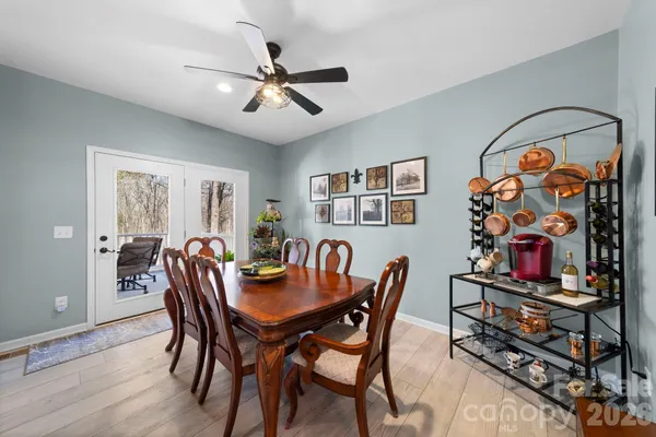 a view of a dining room with furniture and a flat screen tv
