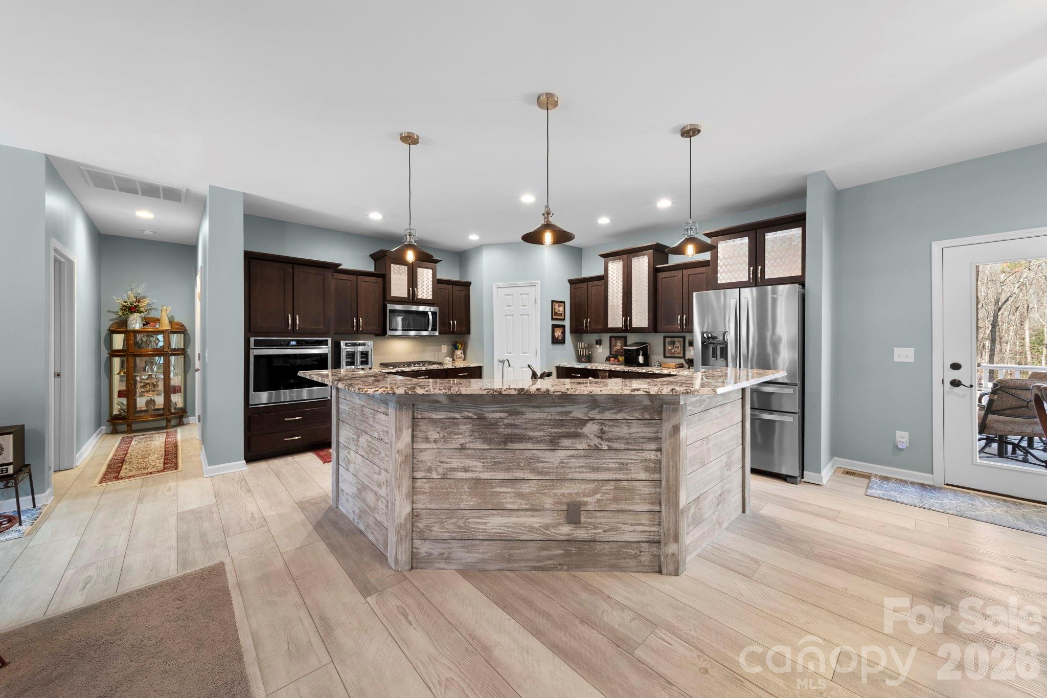 142 Will Evans Road Jefferson, SC 29718 - Photo 35 of 44 a large kitchen with kitchen island a stove a refrigerator a sink dishwasher and a oven with large cabinets