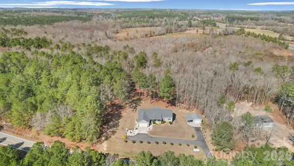 an aerial view of a houses with yard