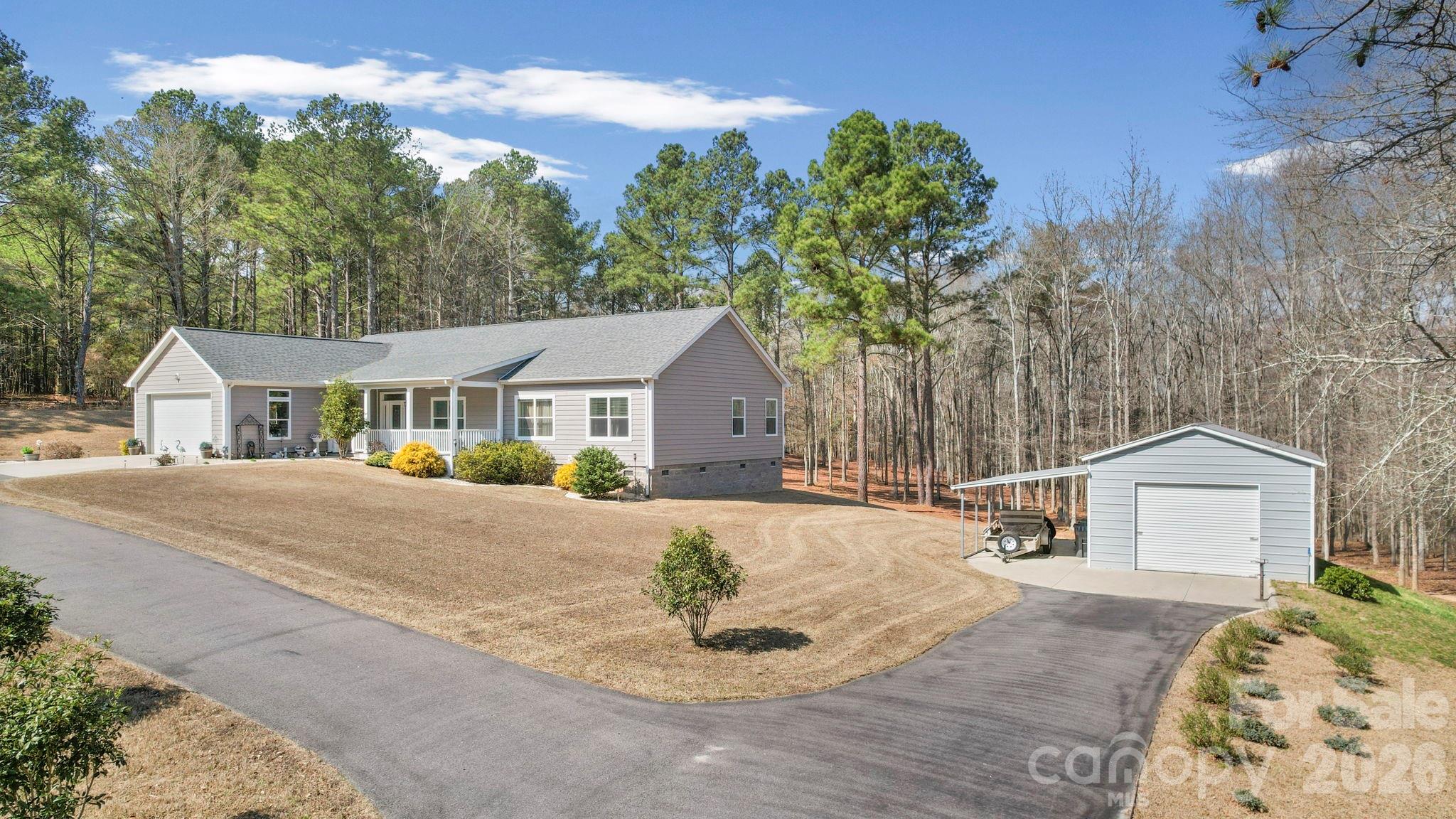 142 Will Evans Road Jefferson, SC 29718 - Photo 42 of 44 a front view of a house with a yard and garage