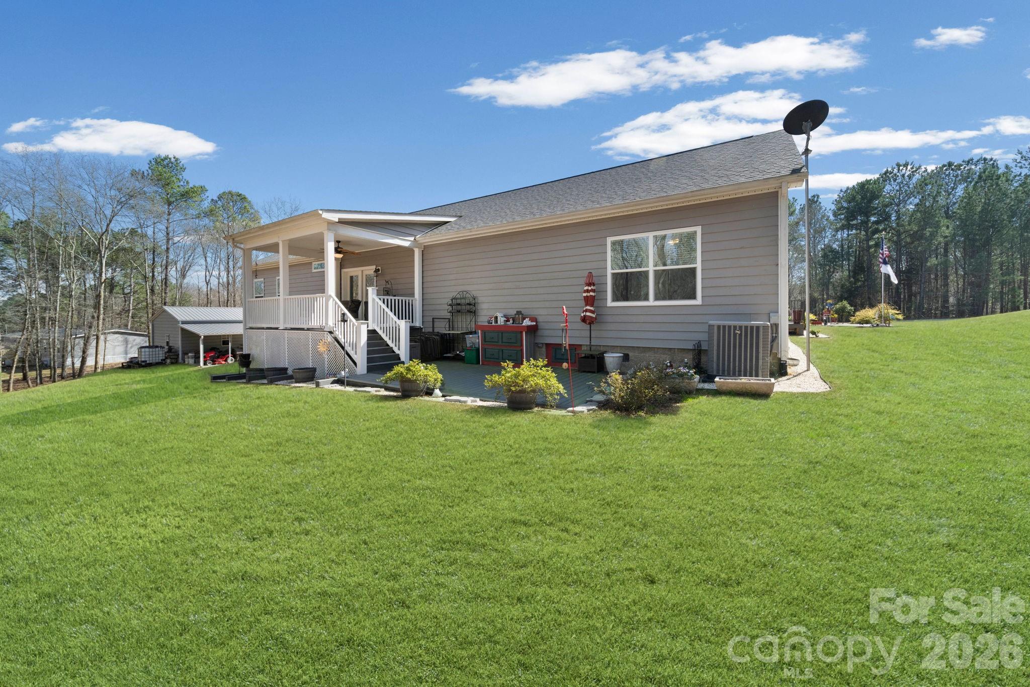 142 Will Evans Road Jefferson, SC 29718 - Photo 6 of 44 a view of a house with backyard sitting area and garden