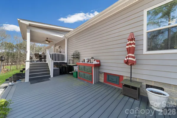 a view of a deck with wooden floor and seating space