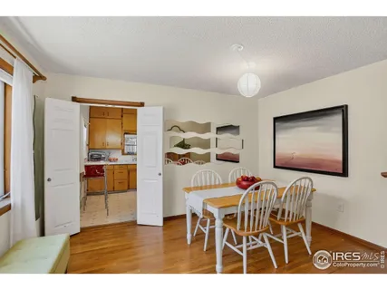 a dining room with furniture and wooden floor
