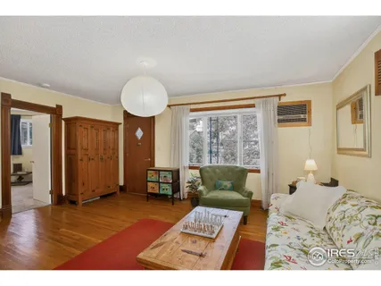 a bedroom with furniture and a large window