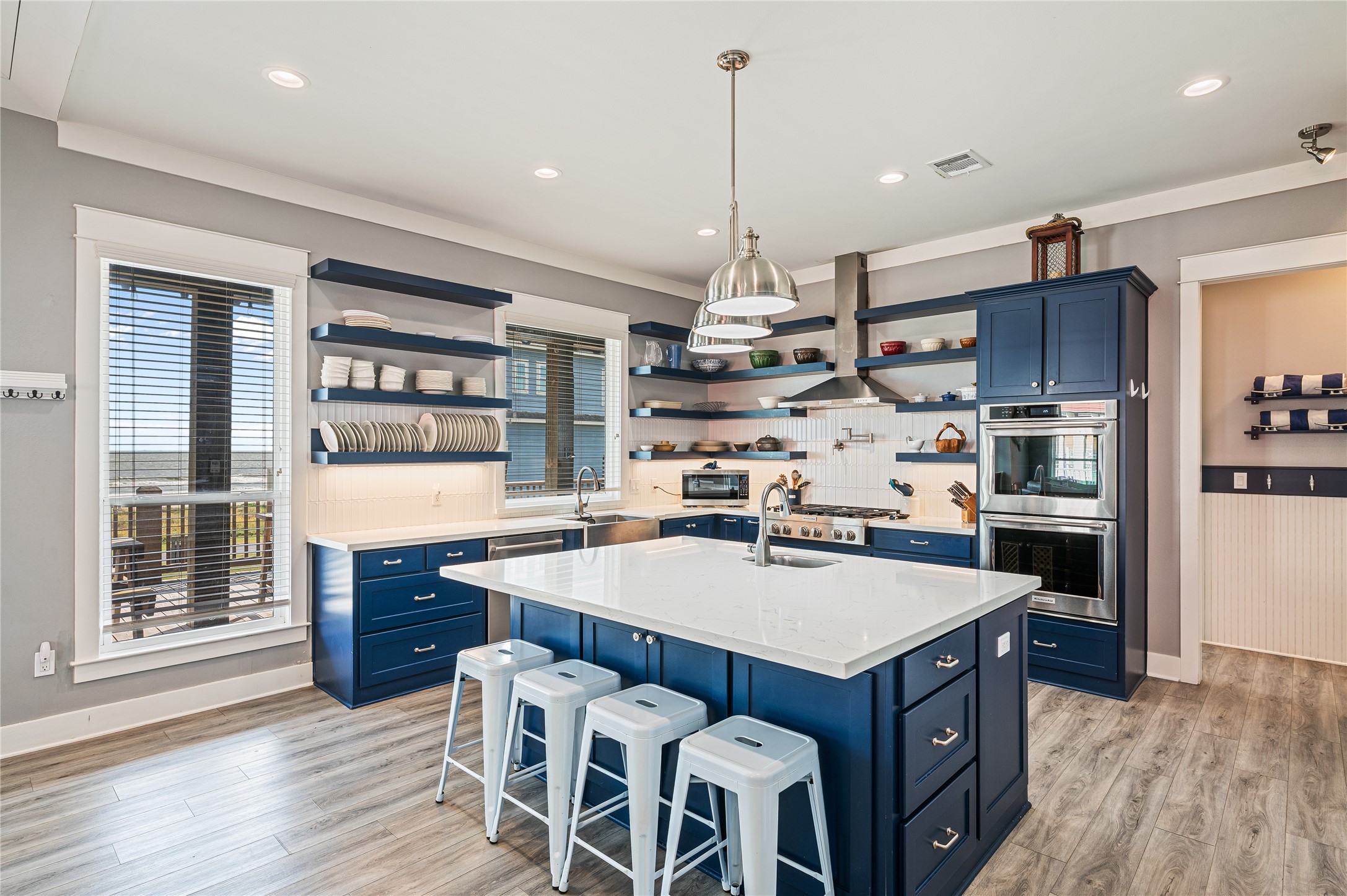 2576 Whitecap Crystal Beach, TX 77650 - Photo 18 of 49 a kitchen with a island a sink stainless steel appliances and wooden floor