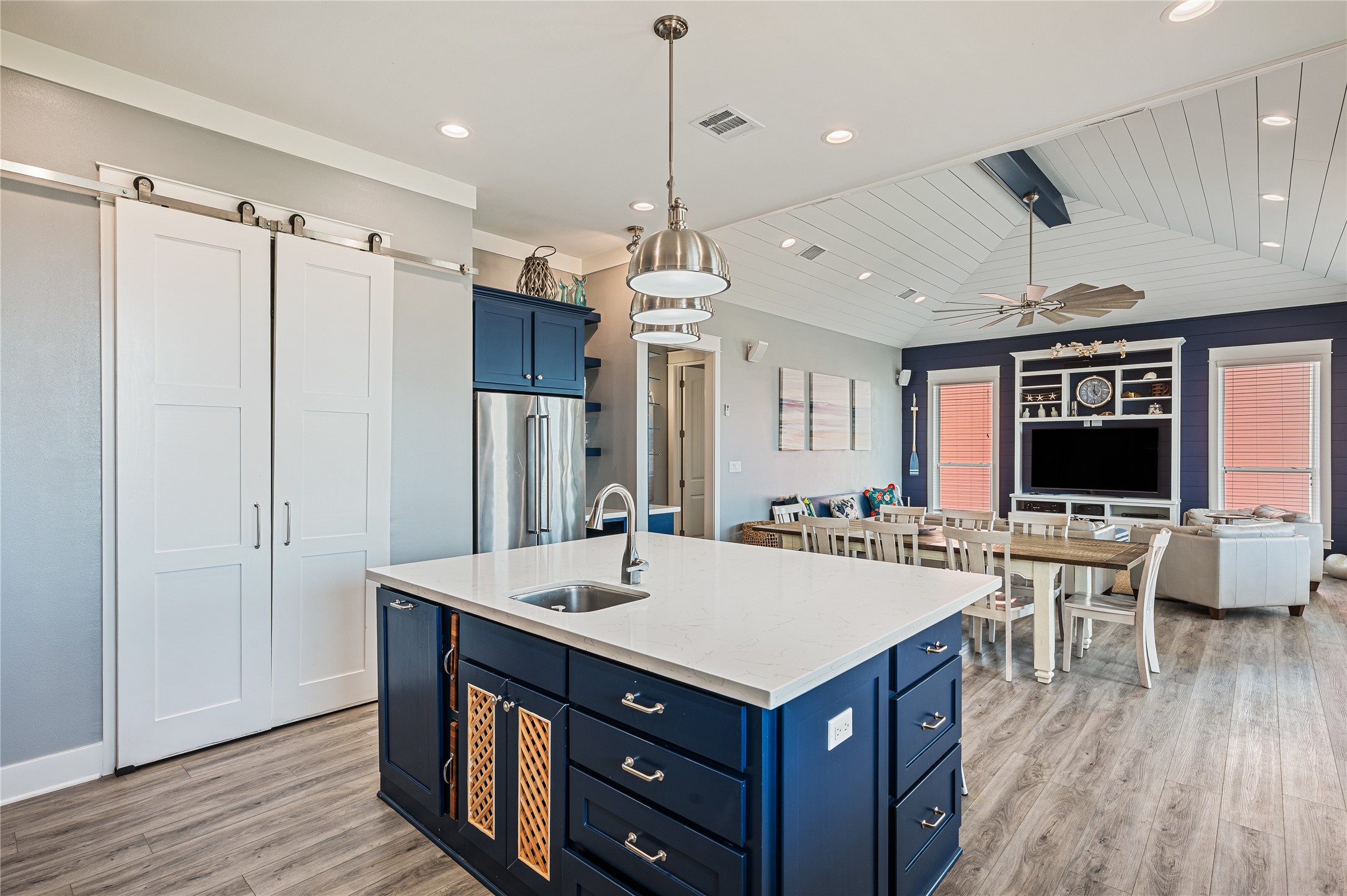 2576 Whitecap Crystal Beach, TX 77650 - Photo 21 of 49 a kitchen with a stove a refrigerator a sink dishwasher with a dining table and chairs with wooden floor