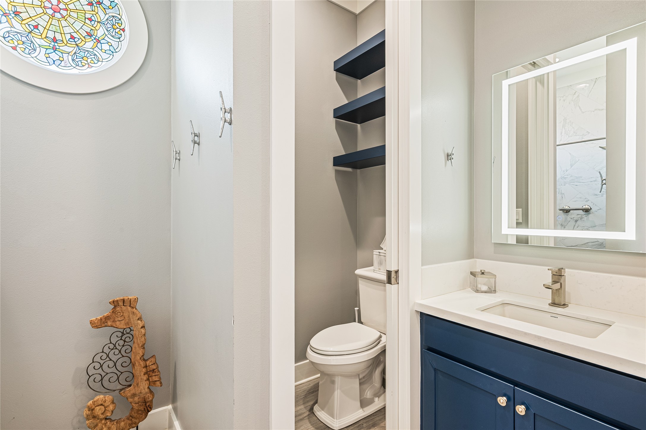 2576 Whitecap Crystal Beach, TX 77650 - Photo 31 of 49 a bathroom with a toilet sink and mirror