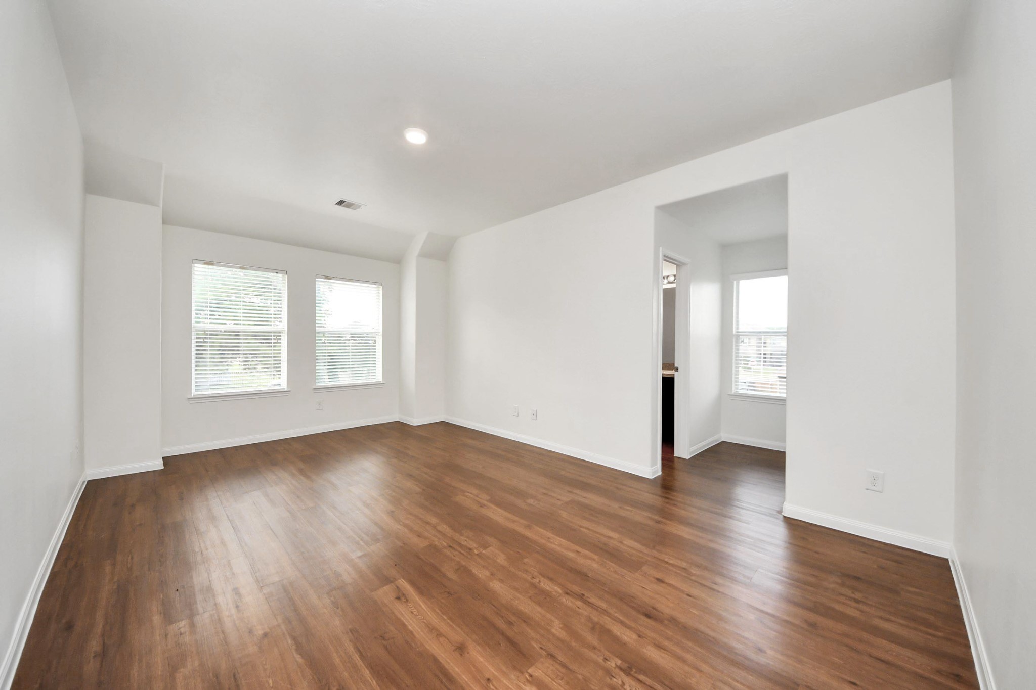 886 Darbydale Crossing Lane Houston, TX 77090 - Photo 19 of 41 an empty room with wooden floor and windows