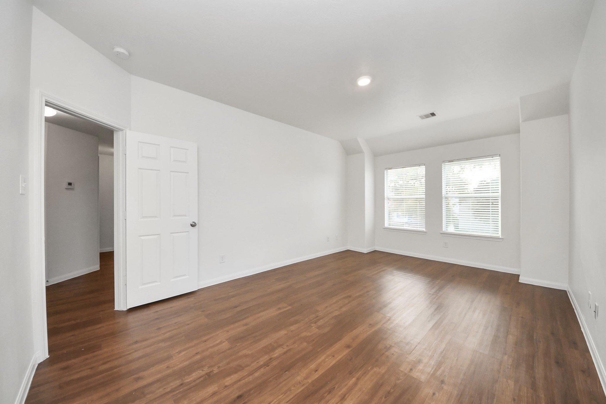 886 Darbydale Crossing Lane Houston, TX 77090 - Photo 22 of 41 an empty room with wooden floor and windows