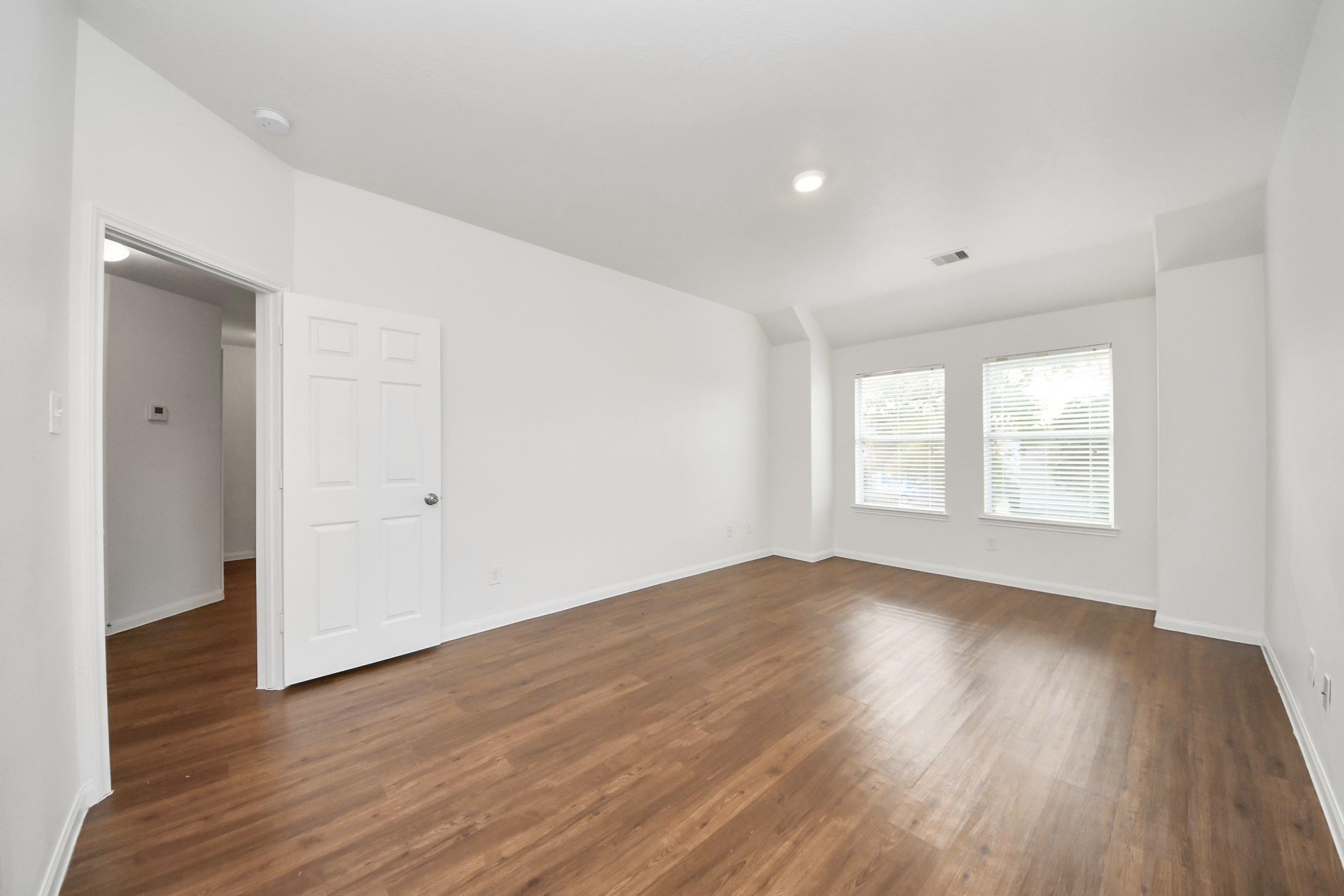 886 Darbydale Crossing Lane Houston, TX 77090 - Photo 23 of 41 an empty room with wooden floor and windows