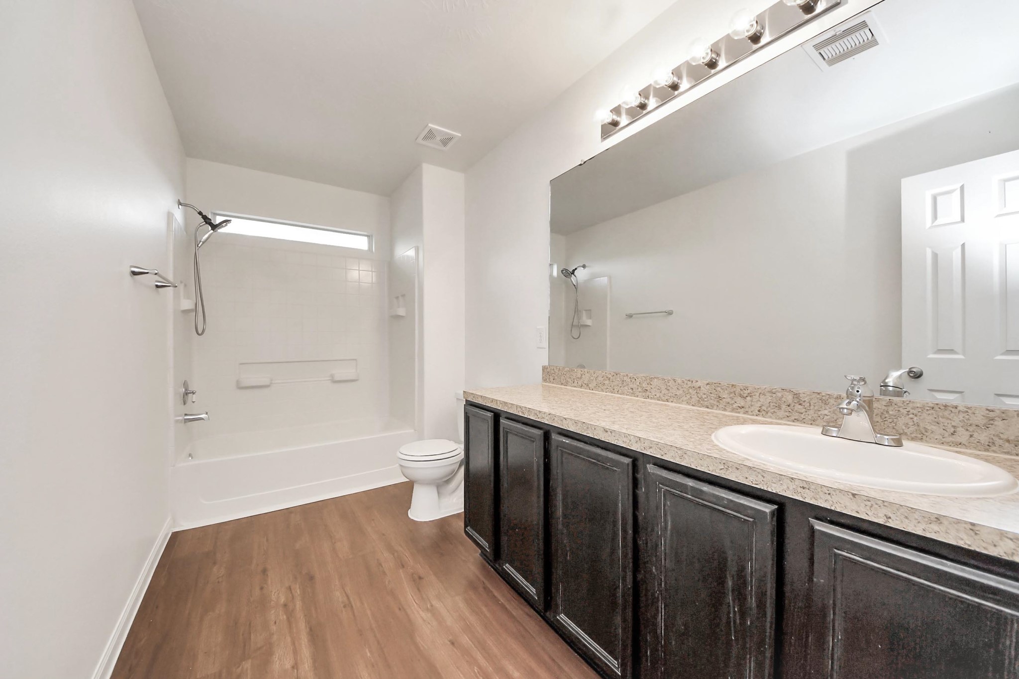886 Darbydale Crossing Lane Houston, TX 77090 - Photo 24 of 41 a bathroom with a granite countertop sink a toilet a shower and a mirror