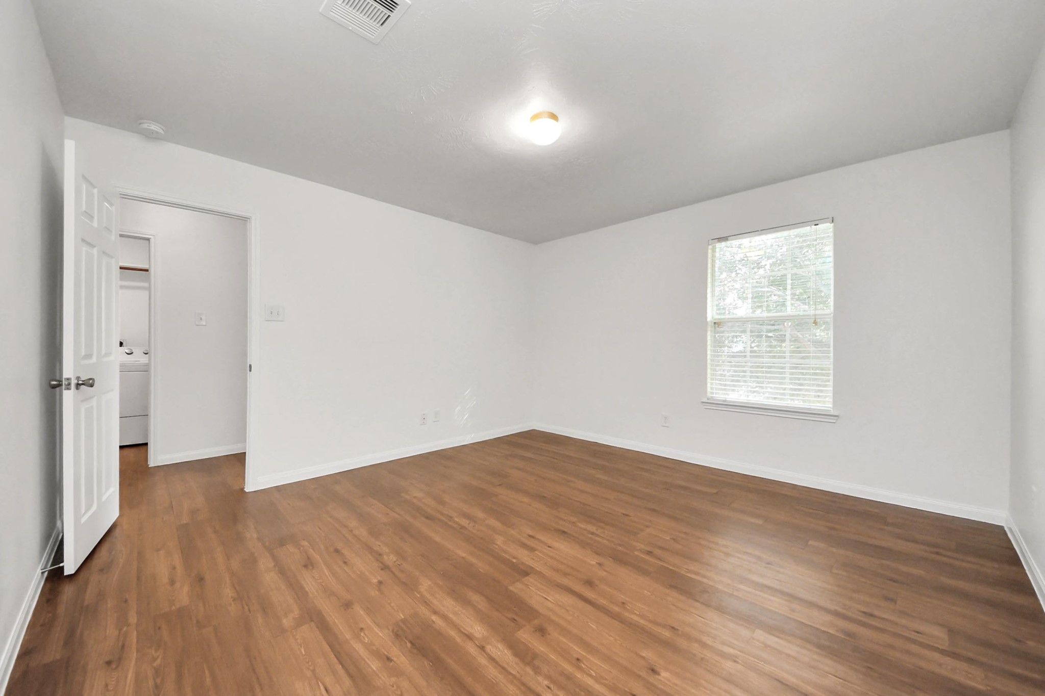 886 Darbydale Crossing Lane Houston, TX 77090 - Photo 34 of 41 wooden floor in an empty room with a window