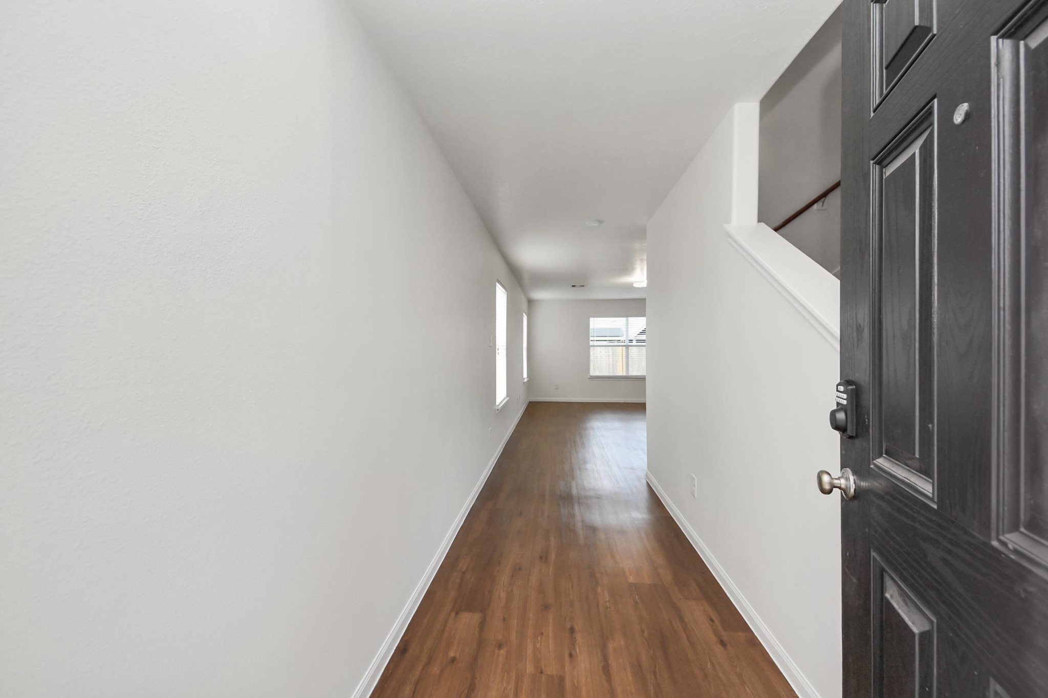 886 Darbydale Crossing Lane Houston, TX 77090 - Photo 6 of 41 a view of a hallway with wooden floor and staircase