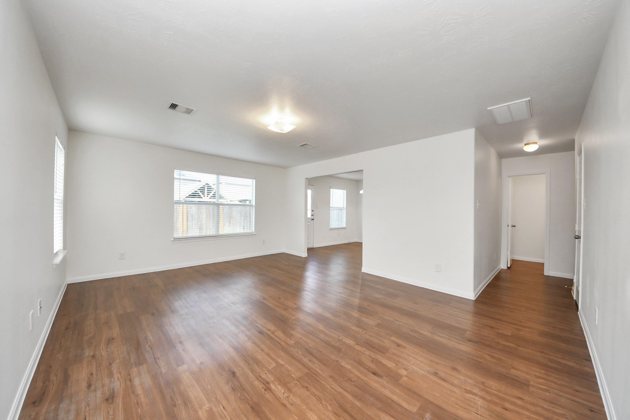 886 Darbydale Crossing Lane Houston, TX 77090 - Photo 7 of 41 an empty room with wooden floor and windows