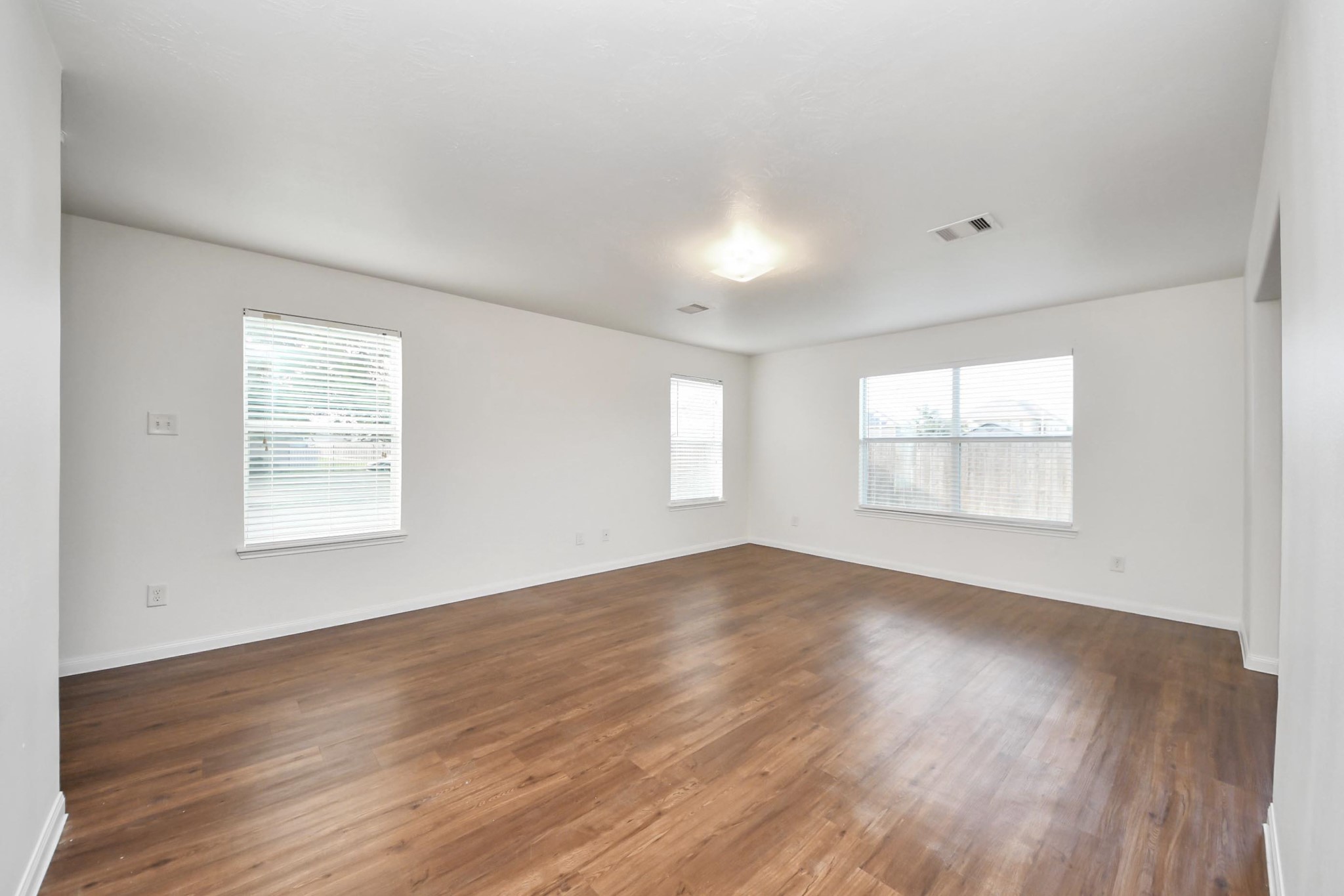 886 Darbydale Crossing Lane Houston, TX 77090 - Photo 10 of 41 an empty room with wooden floor and windows