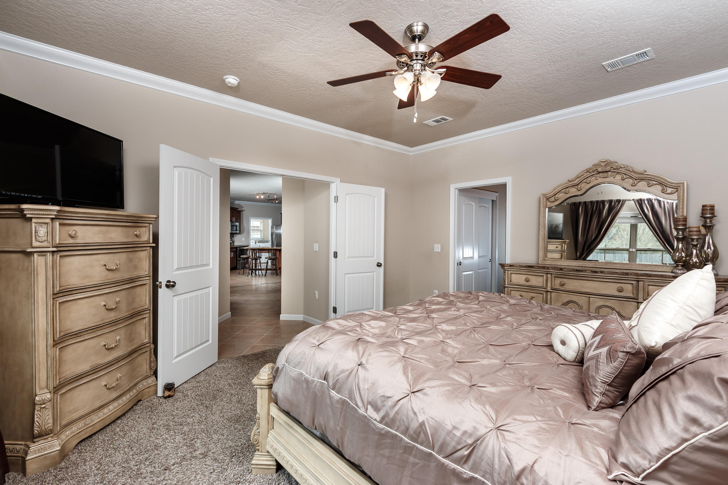 4600 Hermosa Road Crestview, FL 32539 - Photo 14 of 40 a bedroom with a bed and a flat screen tv