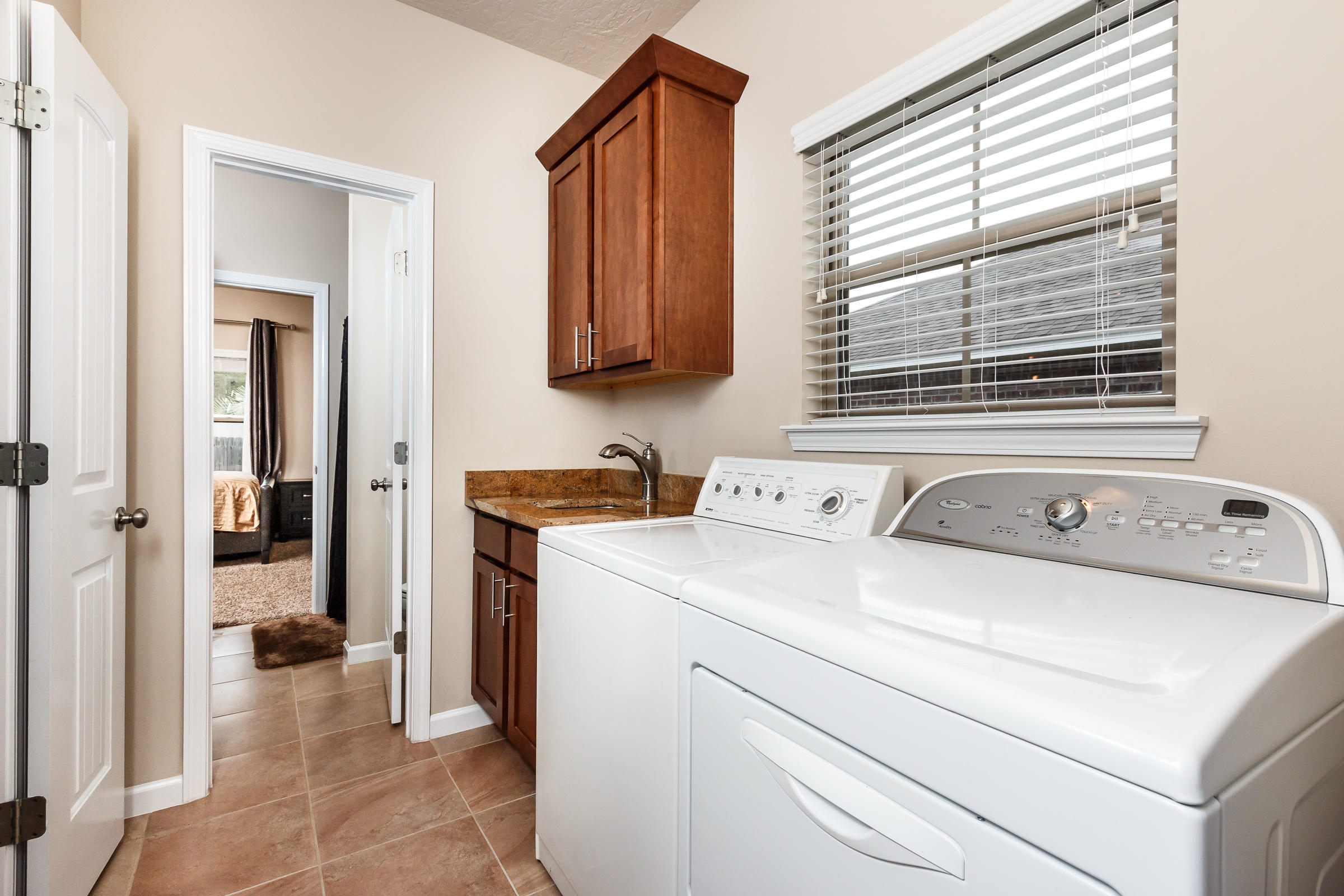 4600 Hermosa Road Crestview, FL 32539 - Photo 23 of 40 a view of washer and dryer with bathroom in the background