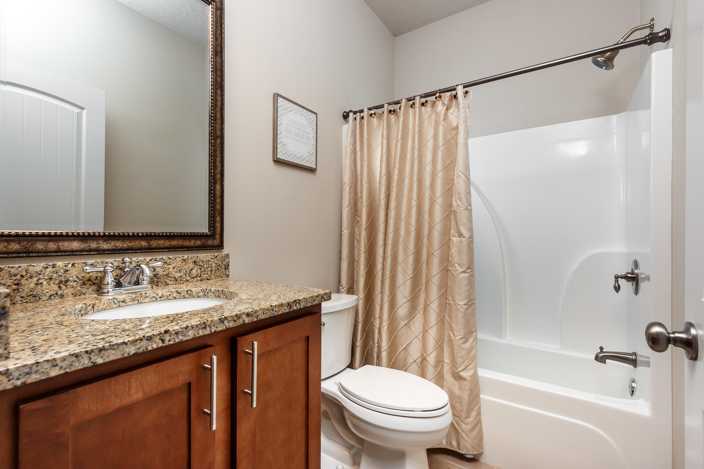 4600 Hermosa Road Crestview, FL 32539 - Photo 30 of 40 a bathroom with a granite countertop sink toilet and shower