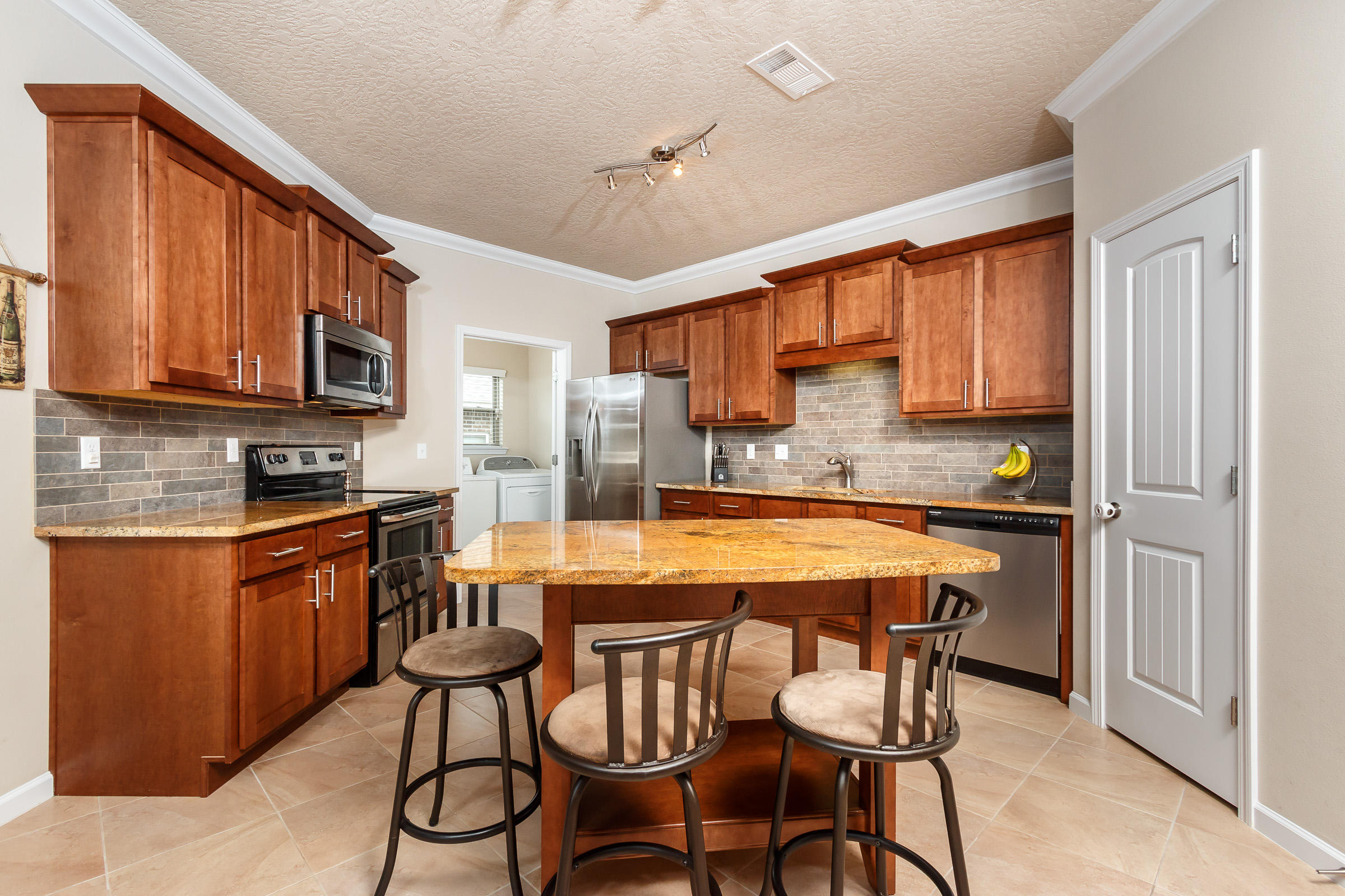 4600 Hermosa Road Crestview, FL 32539 - Photo 4 of 40 a kitchen with stainless steel appliances granite countertop wooden cabinets a stove top oven a sink and dishwasher