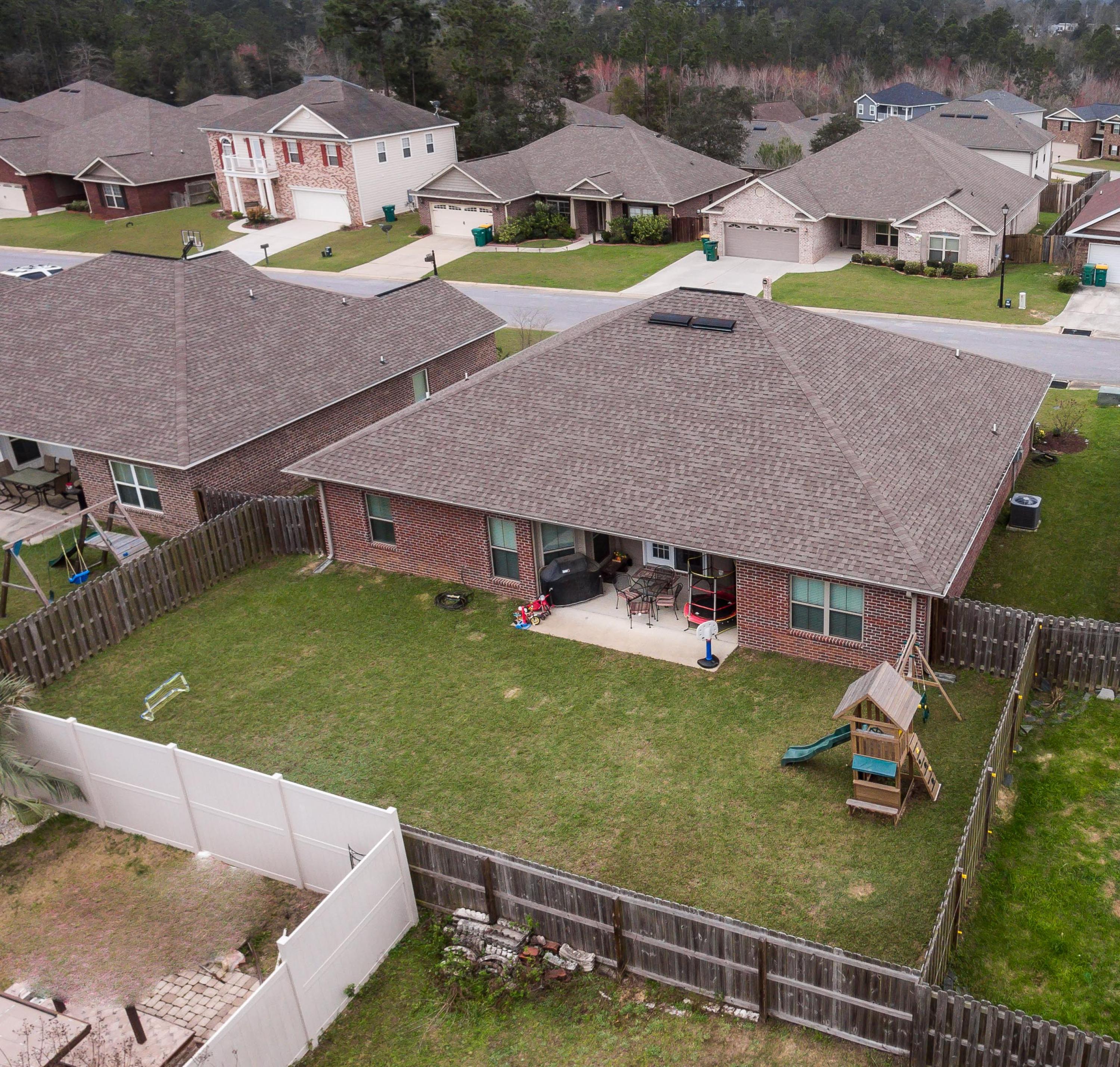 4600 Hermosa Road Crestview, FL 32539 - Photo 40 of 40 an aerial view of a house with swimming pool and a yard