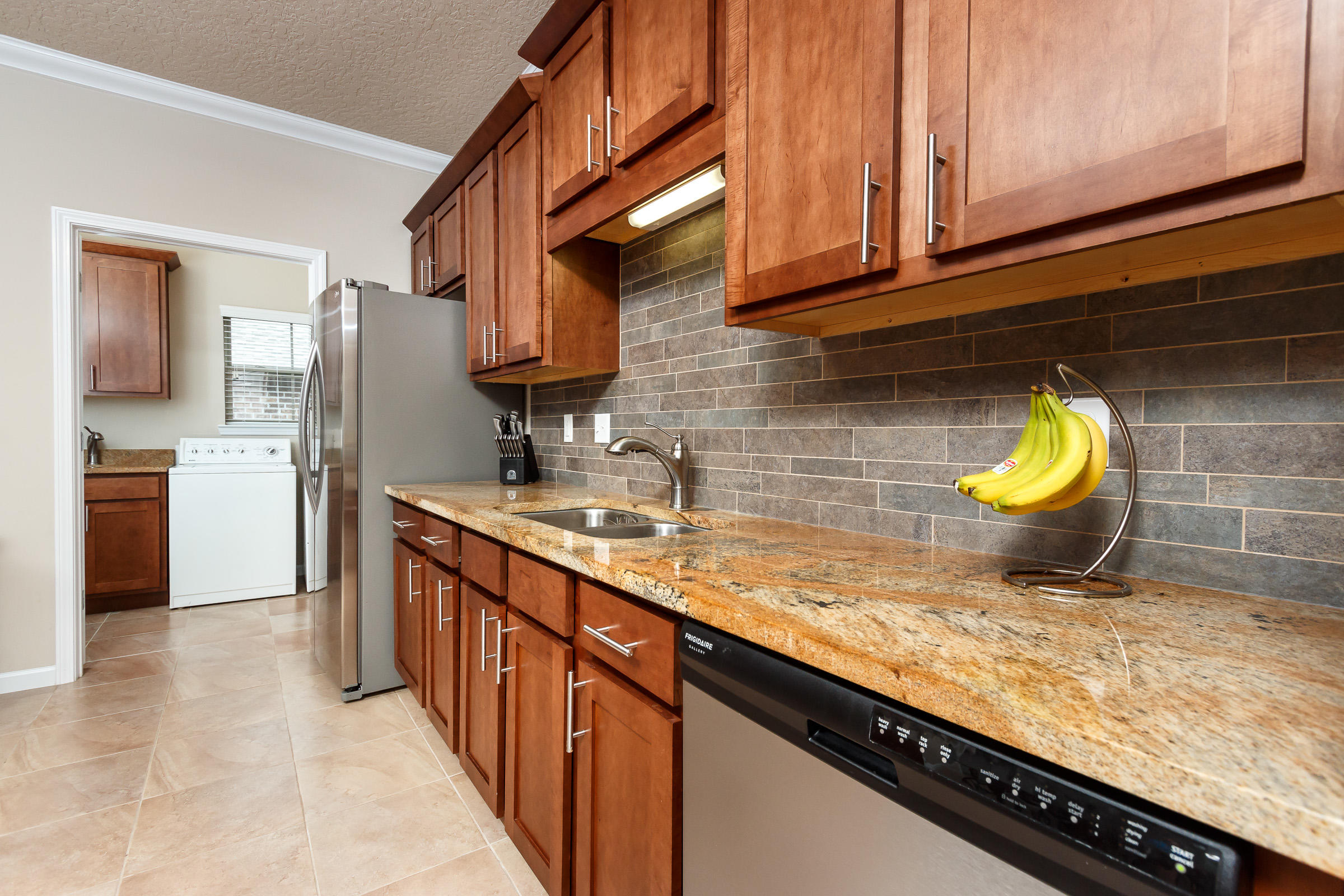 4600 Hermosa Road Crestview, FL 32539 - Photo 5 of 40 a kitchen with stainless steel appliances granite countertop a sink and cabinets